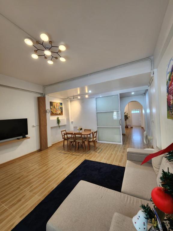a living room with a couch and a table at 198 House in Ban Khlong Pleo
