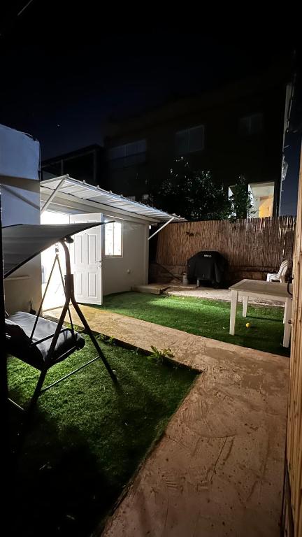 a view of a backyard at night with a tent at בית פרטי ליד הכנרת בקריית שמואל מושלם לאירוח בשבתות ובחגים in Tiberias