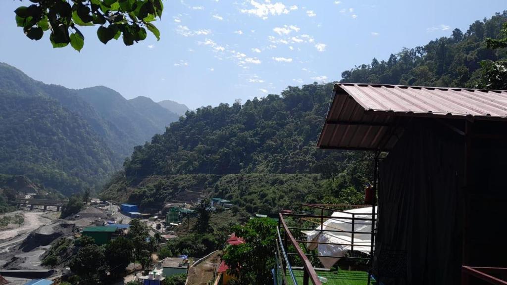 a view of a valley with mountains in the background at Kaafirana Camps in Dhanaulti