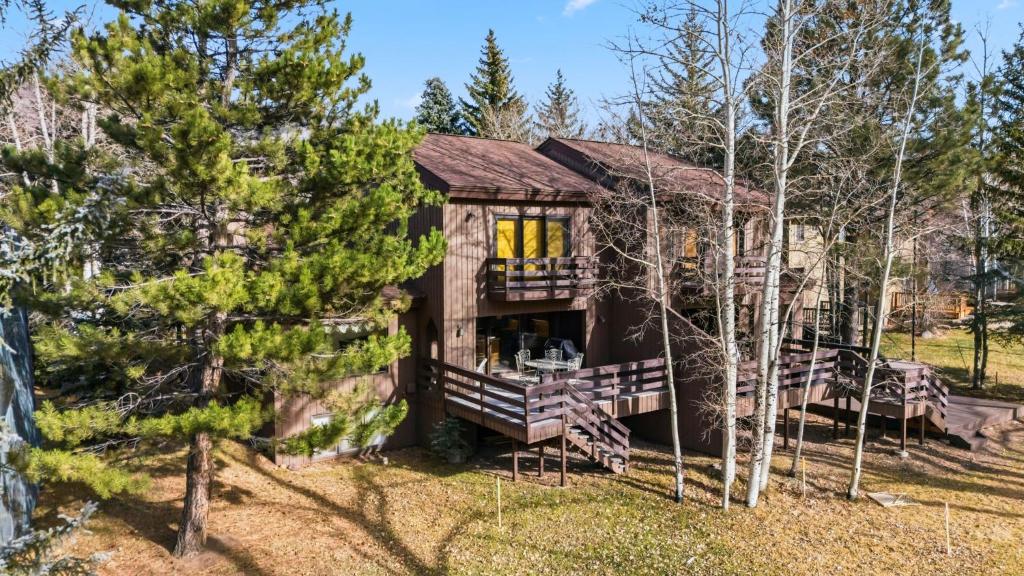 a log cabin in the woods with trees at Mountain View Condo - Hot Tub Fireplace in Avon