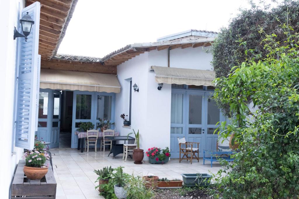 a white house with a patio with a table and chairs at ANANKE Home in Nicosia