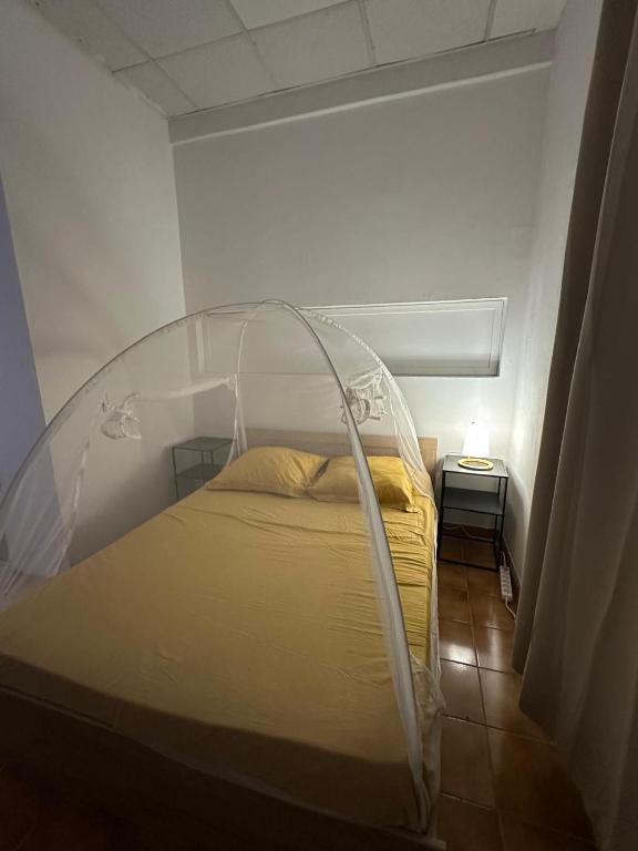a bed with a clear canopy in a room at Tamaly's Lodges in Basse-Terre