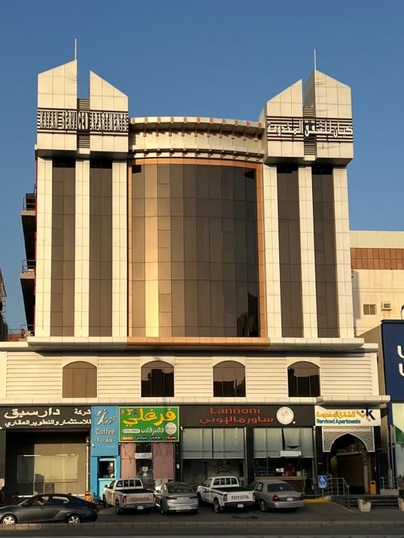 a large building with cars parked in front of it at شقق كيان للشقق المخدومه in Jeddah