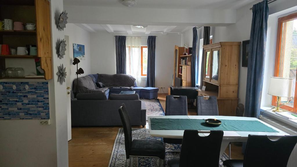 a living room with a table and a couch at Juls garden apartment in Tulln