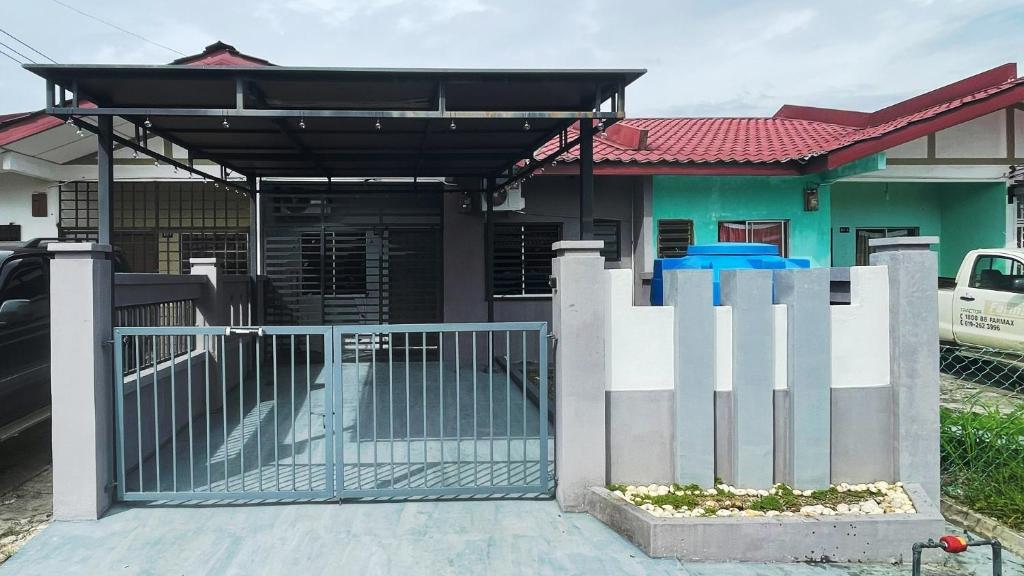 a house with a gate in front of it at Lin Homestay in Lahad Datu