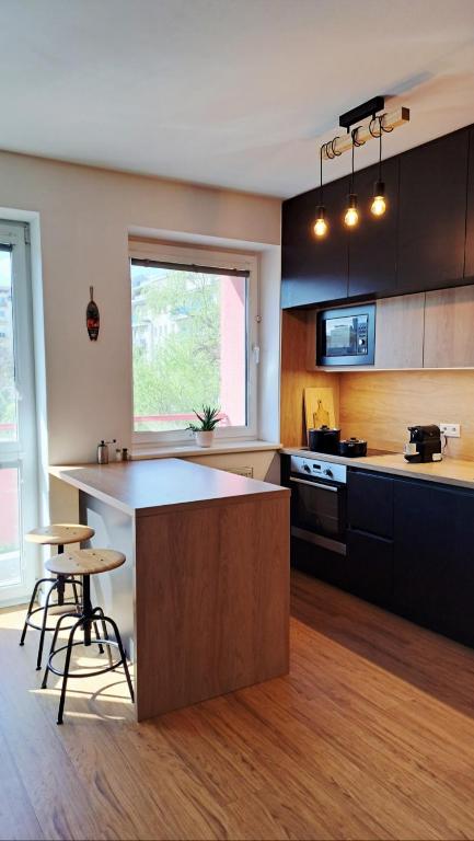 a kitchen with a island in the middle of a room at BLACKWOOD Kitchen in Bratislava