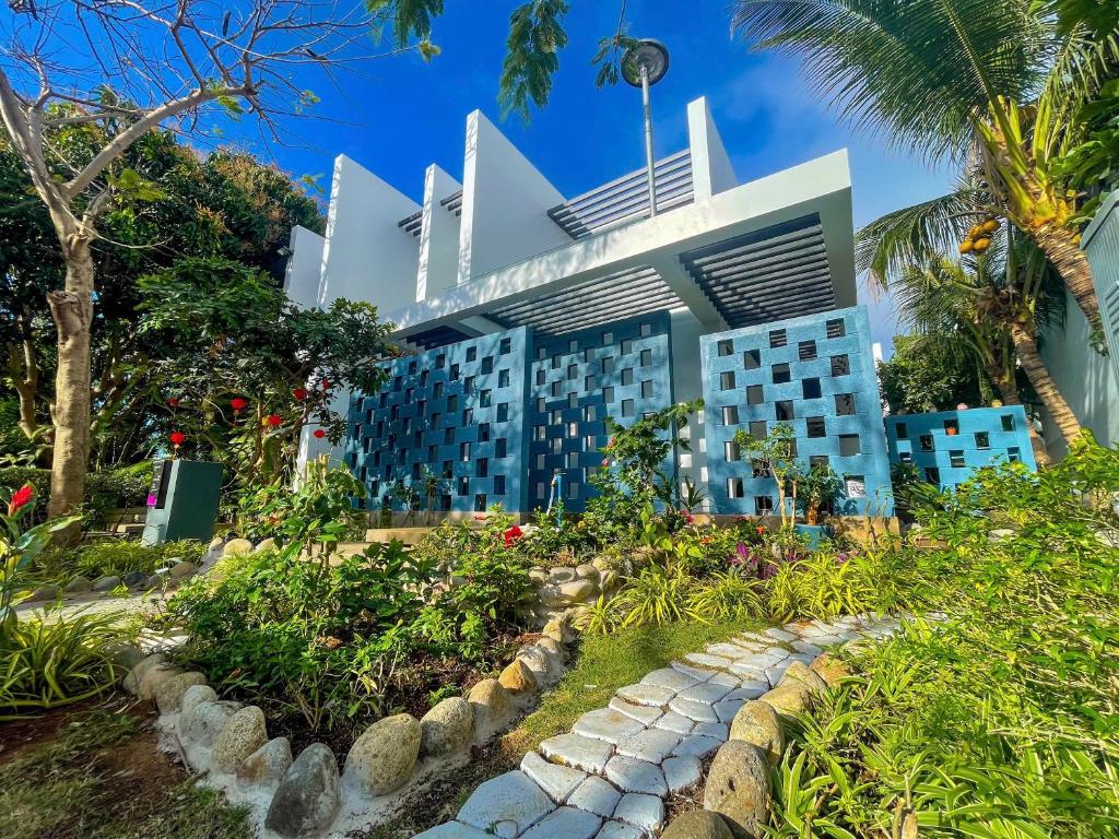 a building with a garden in front of it at Villas 930 Oceanami in Long Hai