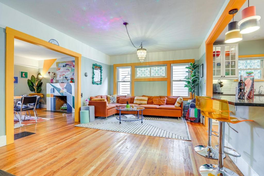 a living room with a couch and a table at Midtown Oasis - BBQ, Deck, Games & Artistic Vibes in Sacramento