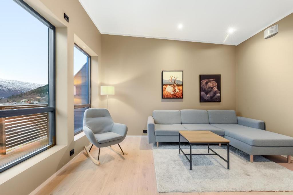 a living room with a couch and a table at Aurora Apartments - Mountain View in Stryn