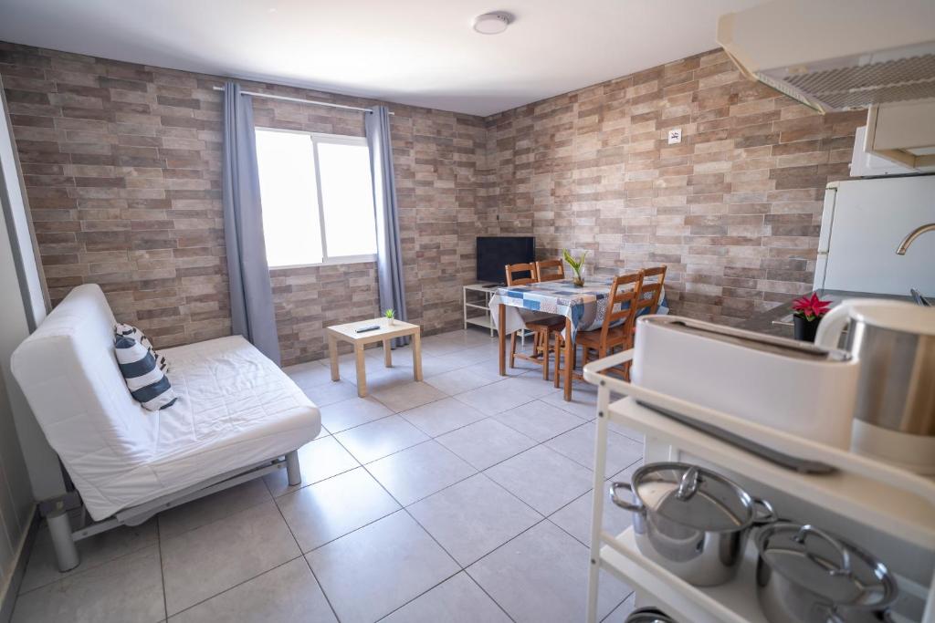 a kitchen and living room with a table and chairs at Edificio Prieto VIV 5 in Puerto del Rosario