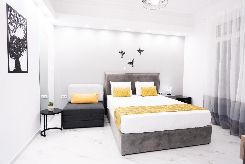 a bedroom with a large bed and a chair at Syntagma Luxury Apartment in Athens
