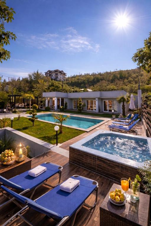 a backyard with a swimming pool and a house at Villa Dimo Topal Luxury Suites with Pool & Jacuzzi in Ohrid