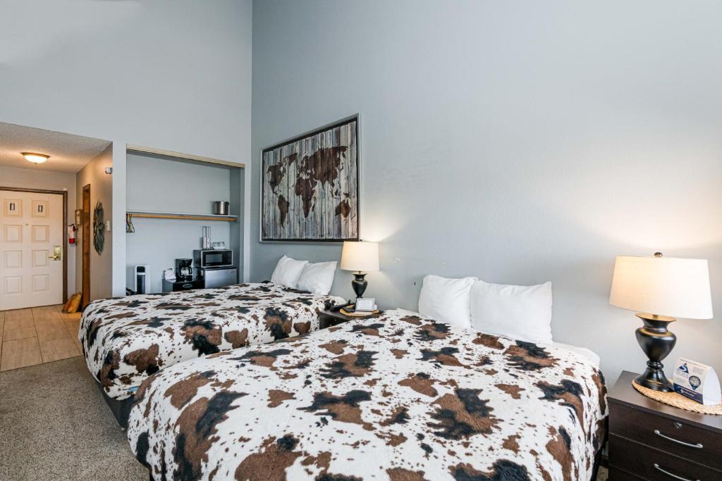 a hotel room with two beds and two lamps at 645 Silvercreek Inn Room in Granby