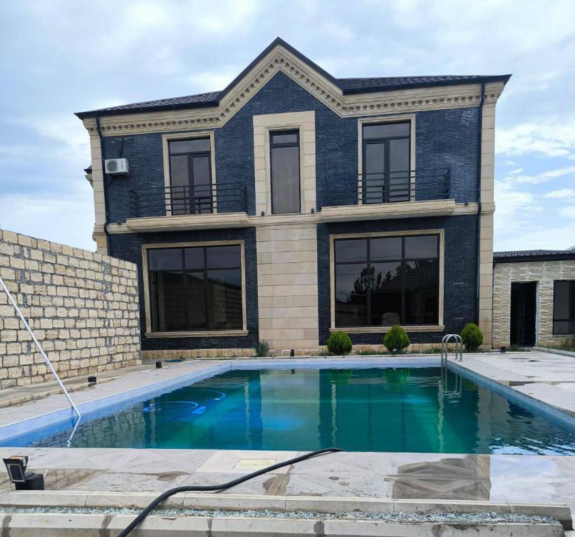 a house with a swimming pool in front of it at Billa Sea breeze in Baku