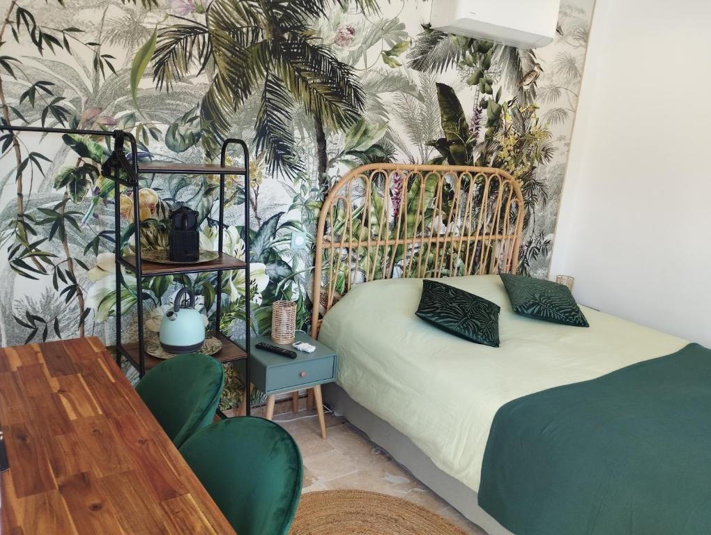 a bedroom with a bed and a plant wall at Chambre 2 pers SPA Piscine in Grospierres