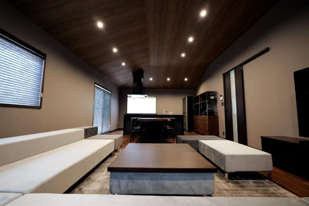 a living room with a couch and a piano at 龍宿 Noboru Yado in Kagoshima