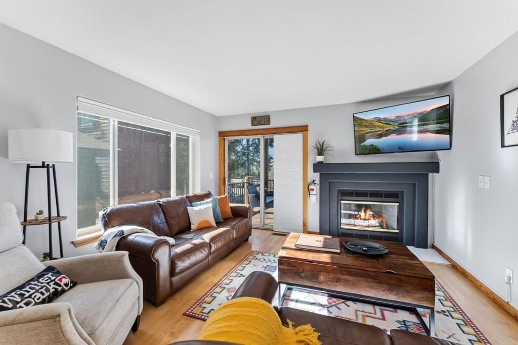 a living room with a couch and a fireplace at 820 Badger Ln in Fraser