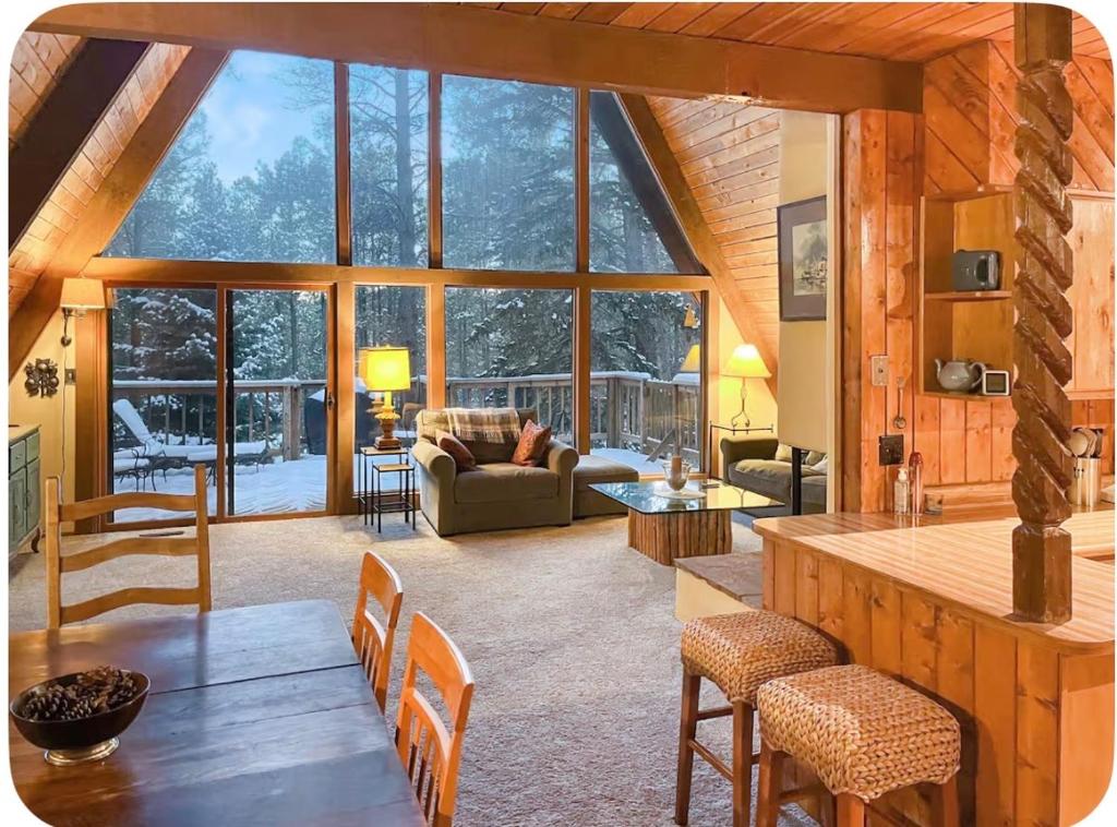 a large living room with a table and chairs at Elevation Station Surrounded by Wildlife in Angel Fire