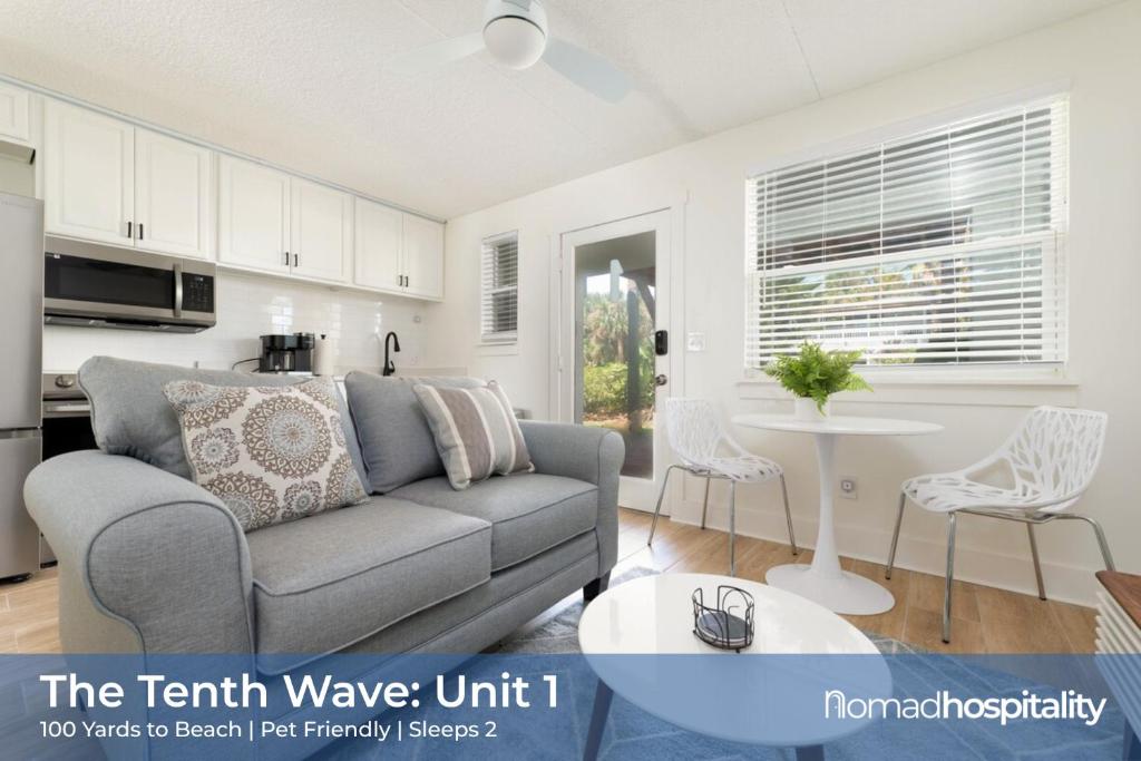 a living room with a couch and a table at Be A Nomad - Beachside Apartments in Jacksonville Beach