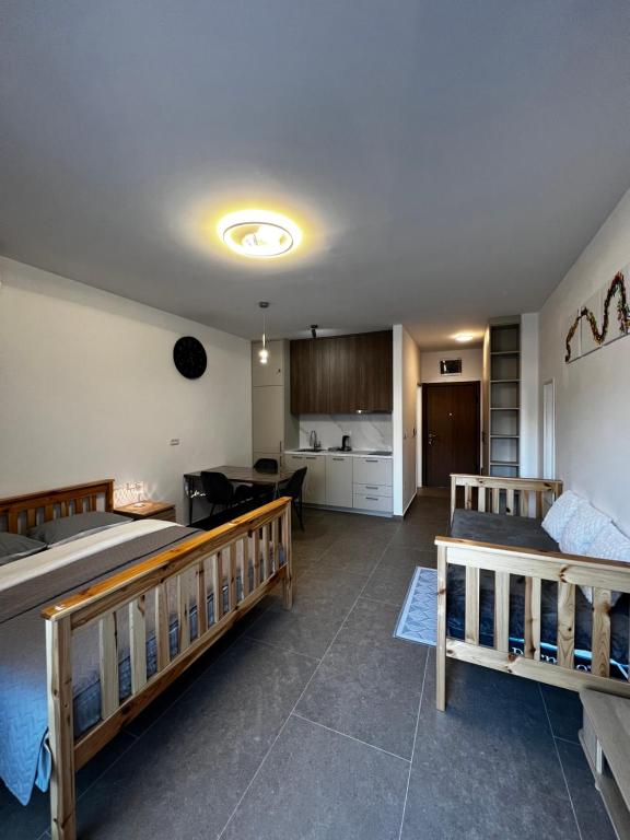 a living room with two beds and a kitchen at DEYA Apartment Becici in Boreti