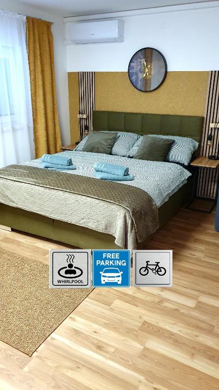 a bedroom with a bed and signs on the floor at Privat Inn in Rakvice
