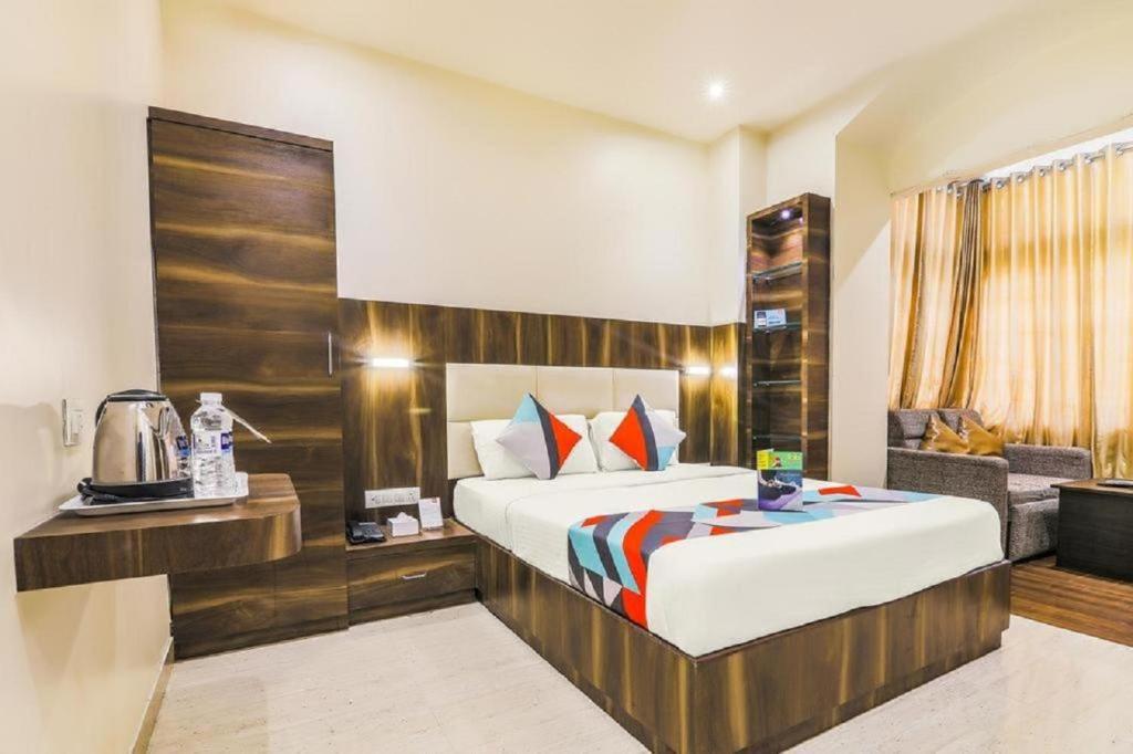 a hotel room with a bed and a couch at Hotel Square Plaza At Airport in New Delhi