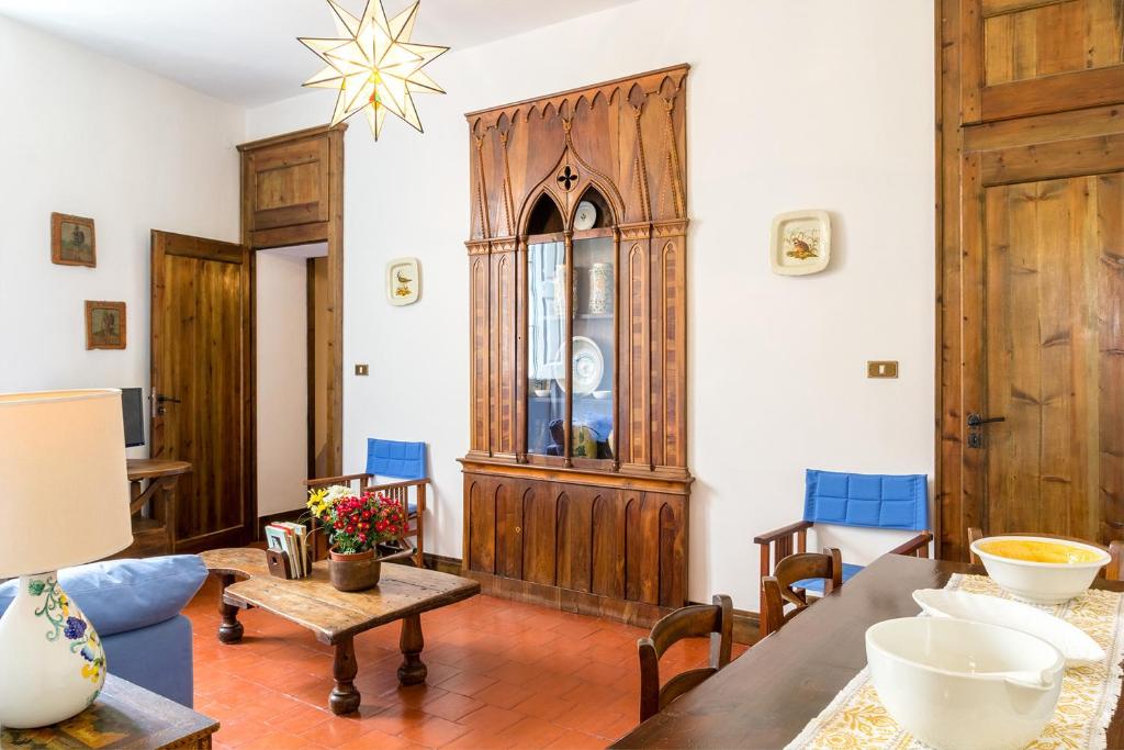 a living room with a table and blue chairs at SUITE MARINELLA -TAORMINA in Taormina