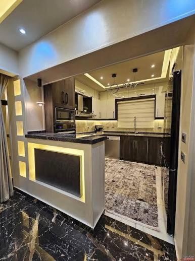 a large kitchen with a large island in the middle at روف كامل خصيصا لك in Madīnat ash Shurūq