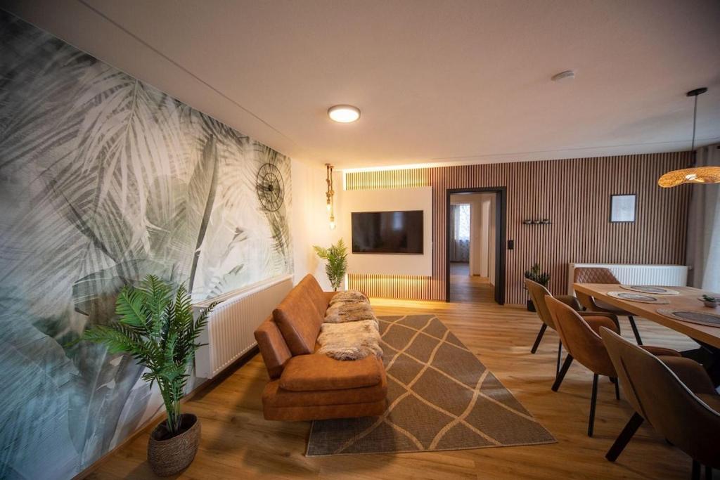 a living room with a large painting on the wall at Boho vibes between mountains and lakes in Schlier