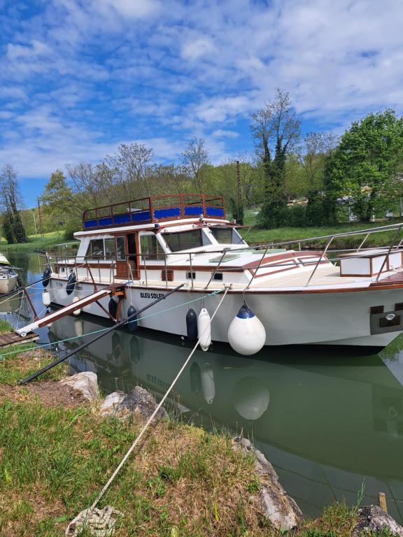 two boats are docked in the water on a lake at Bleu soleil in Dieupentale