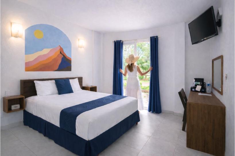 Un pat sau paturi într-o cameră la Hotel Juarez 70