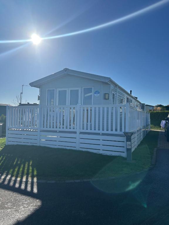 a large white house with a white fence at haven kent coast in Allhallows