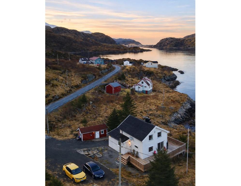 an aerial view of a house and a road next to a lake at Oceanview Escape Lofoten in Ramberg