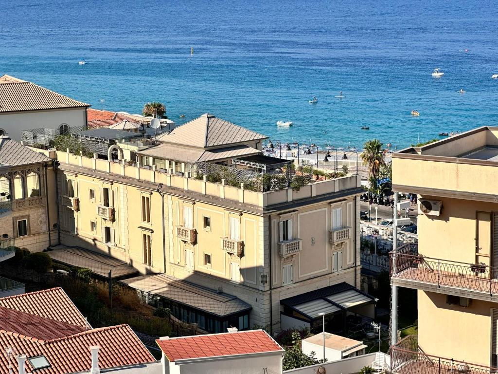 an aerial view of a building and the ocean at Blu Opèra Guest Rooms in Soverato Marina