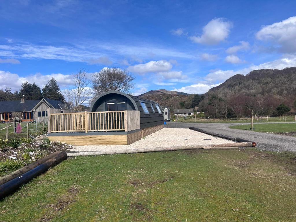 a dome house with a deck on the side of a road at Dalrigh Pod 2 in Onich