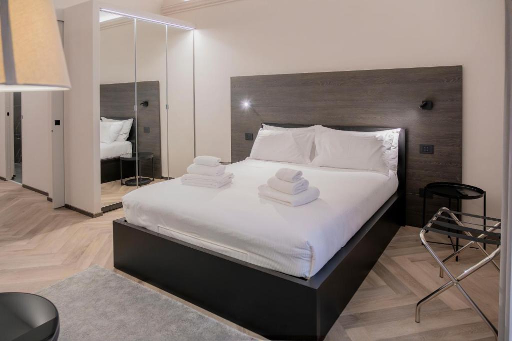 a bedroom with a large bed with towels on it at barneys design apartment in Taranto