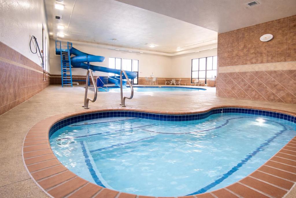 a pool in a hotel room with a swimming pool at Comfort Inn & Suites Rapid City near Mt Rushmore in Rapid City