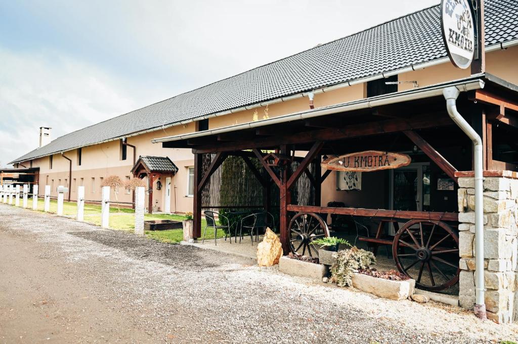 a building with a horse drawn carriage in front of it at Penzion U Kmotra in Borovany