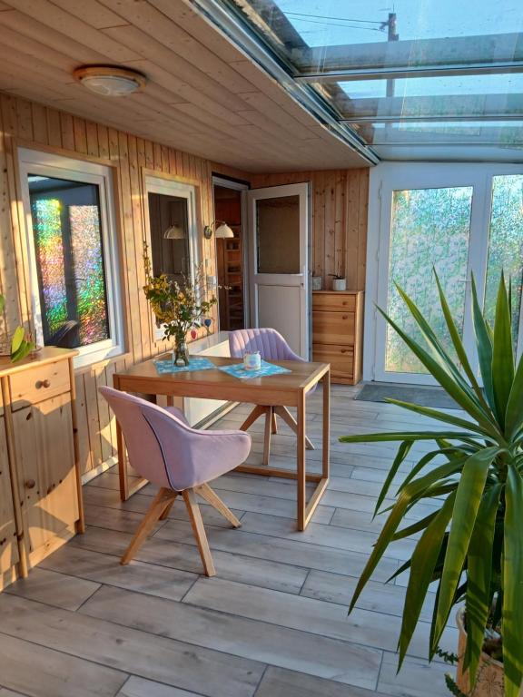a patio with a wooden table and a plant at Haus Elise in Saalfeld