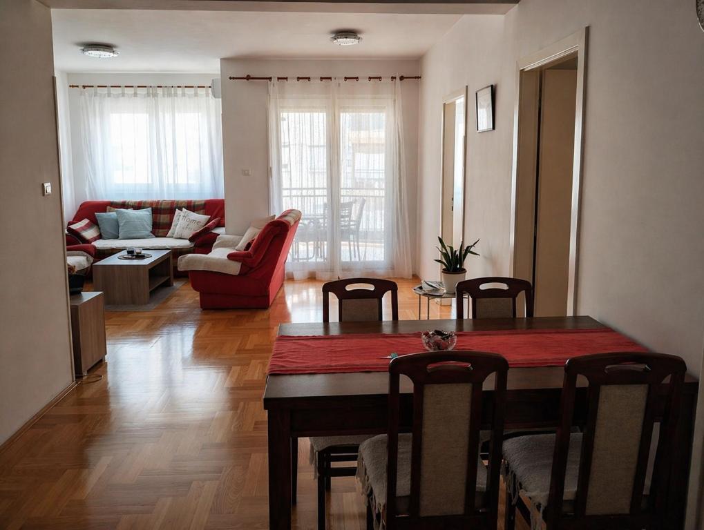 a living room with a table and chairs and a living room at Studio Centar in Trebinje