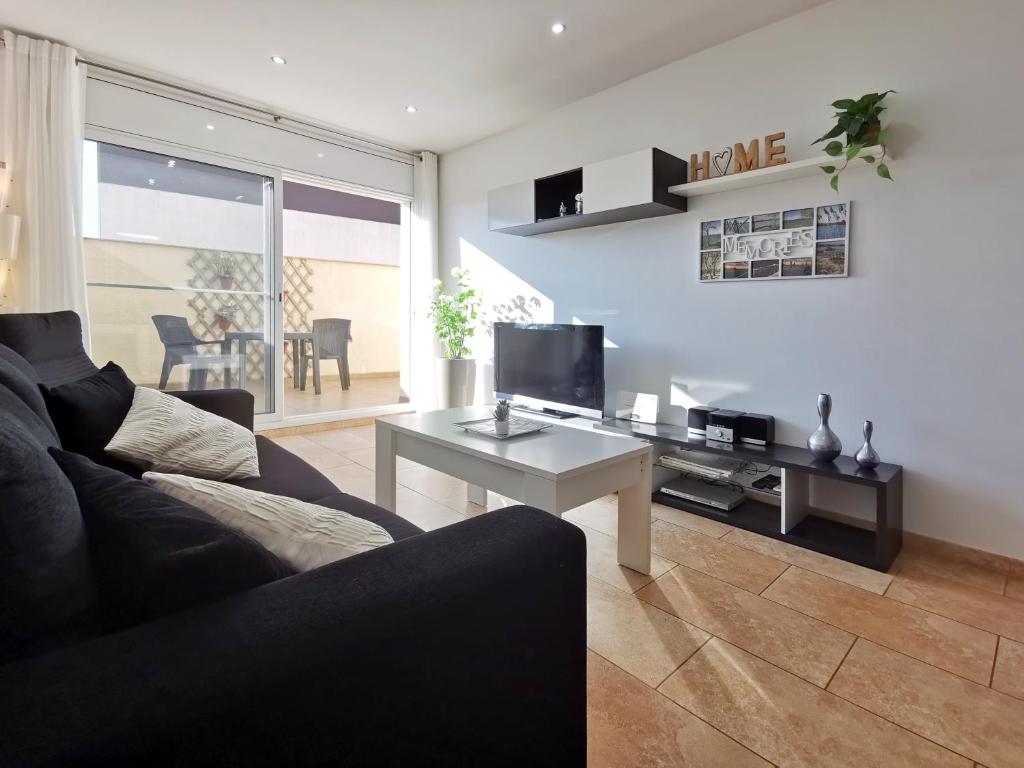 a living room with a couch and a table at Somnis del Delta, Apartamento Deltebre, Delta Ebro in Deltebre