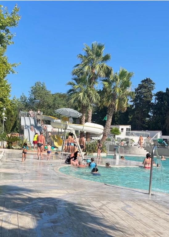 a group of people in the swimming pool at a resort at Mobilhome Ligaropa climatisé 3 ch 6 pers camping des 7 fonts in Agde