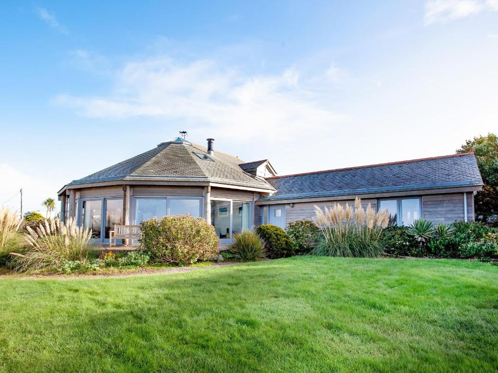 a house with a large lawn in front of it at Shark Fin in Sennen