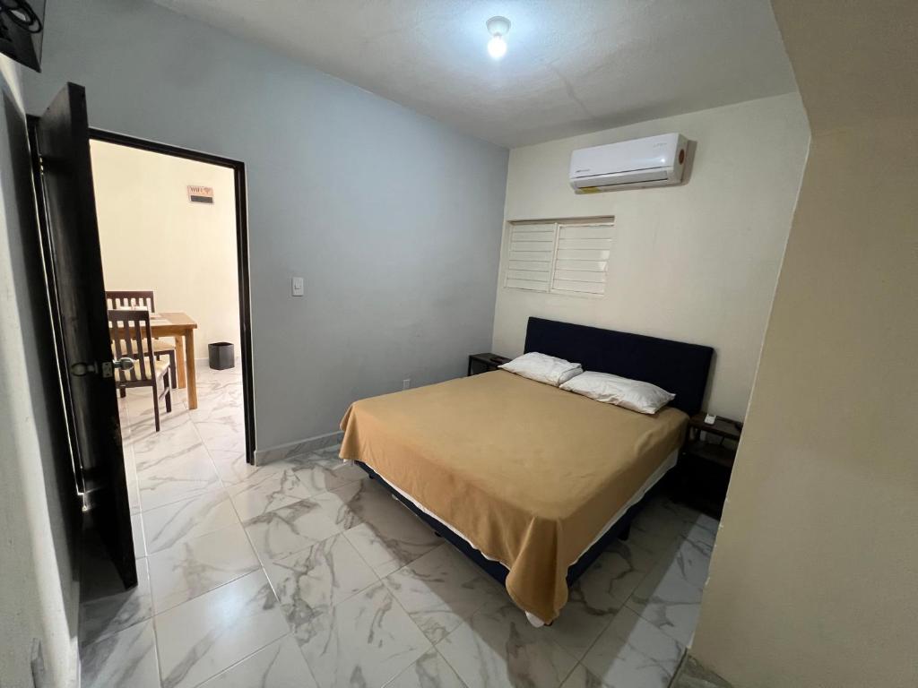 a bedroom with a bed in a room with a mirror at Suite El Ángel #7 in Tuxtla Gutiérrez