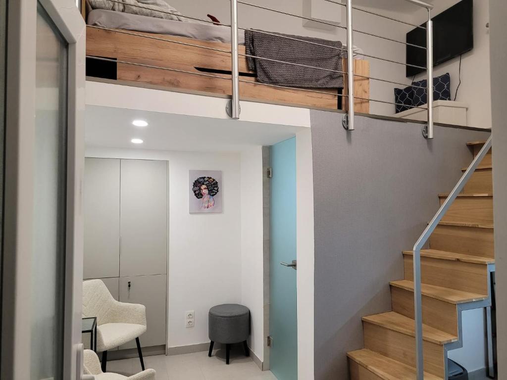 a room with a loft bed and a desk at BEM MINI STUDiO in Budapest