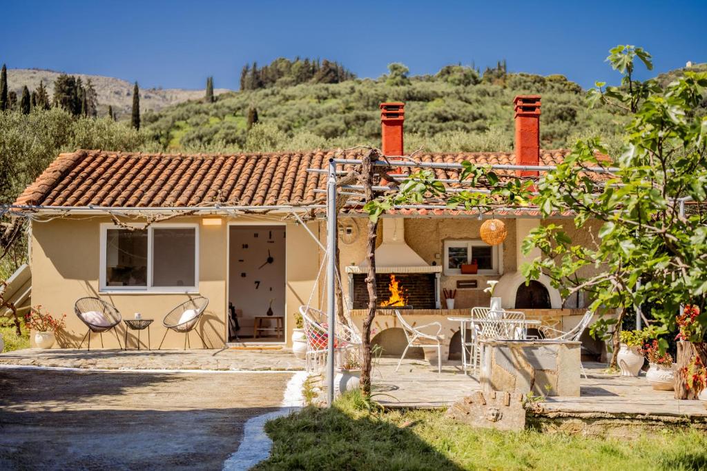 a house with a fireplace in front of it at Destinys Village II in Zakynthos