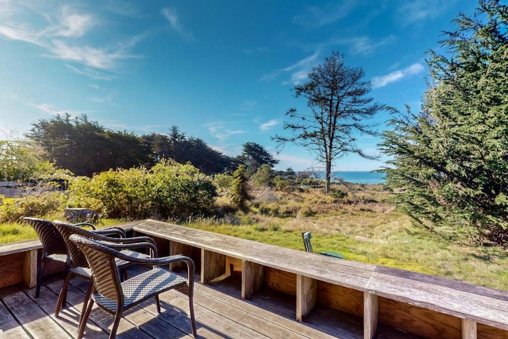 a wooden deck with two chairs and a table at Meyer Getaway in Sea Ranch