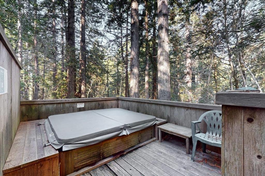 a bed and a bench on a wooden deck at Longwell House in Sea Ranch