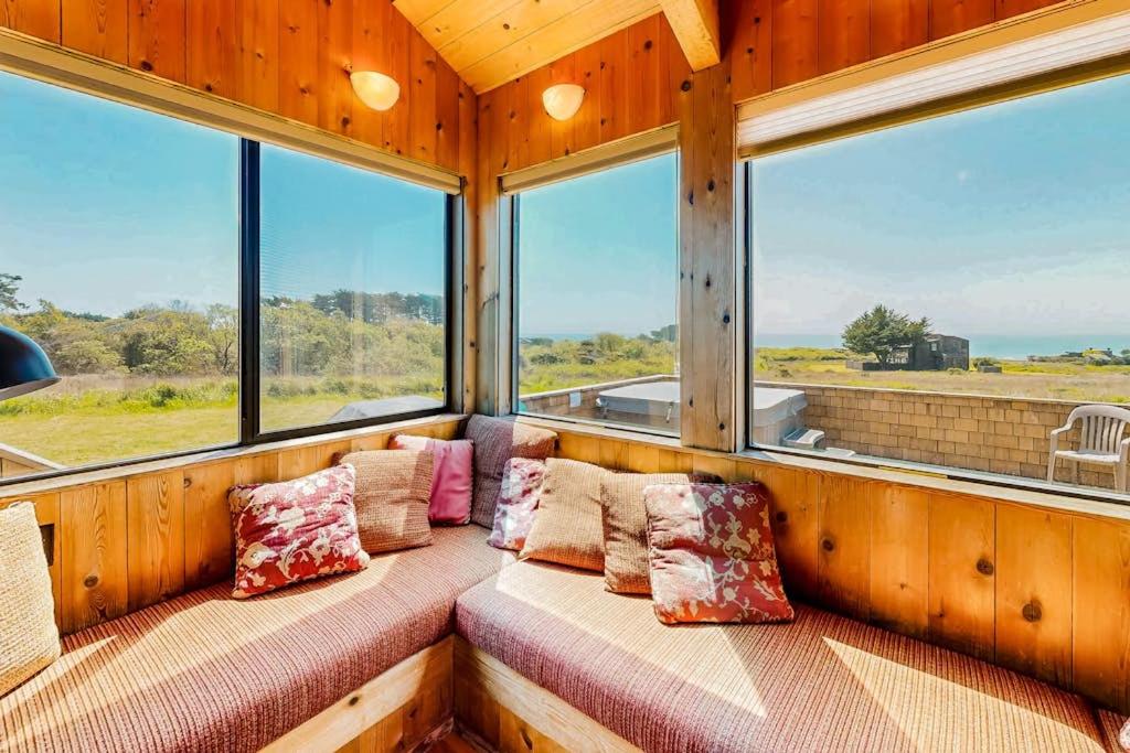 a room with pillows and windows in a house at Cadwalader House in Sea Ranch