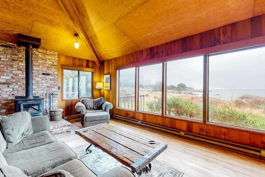 a living room with a couch and a table at Comstock Retreat in Sea Ranch